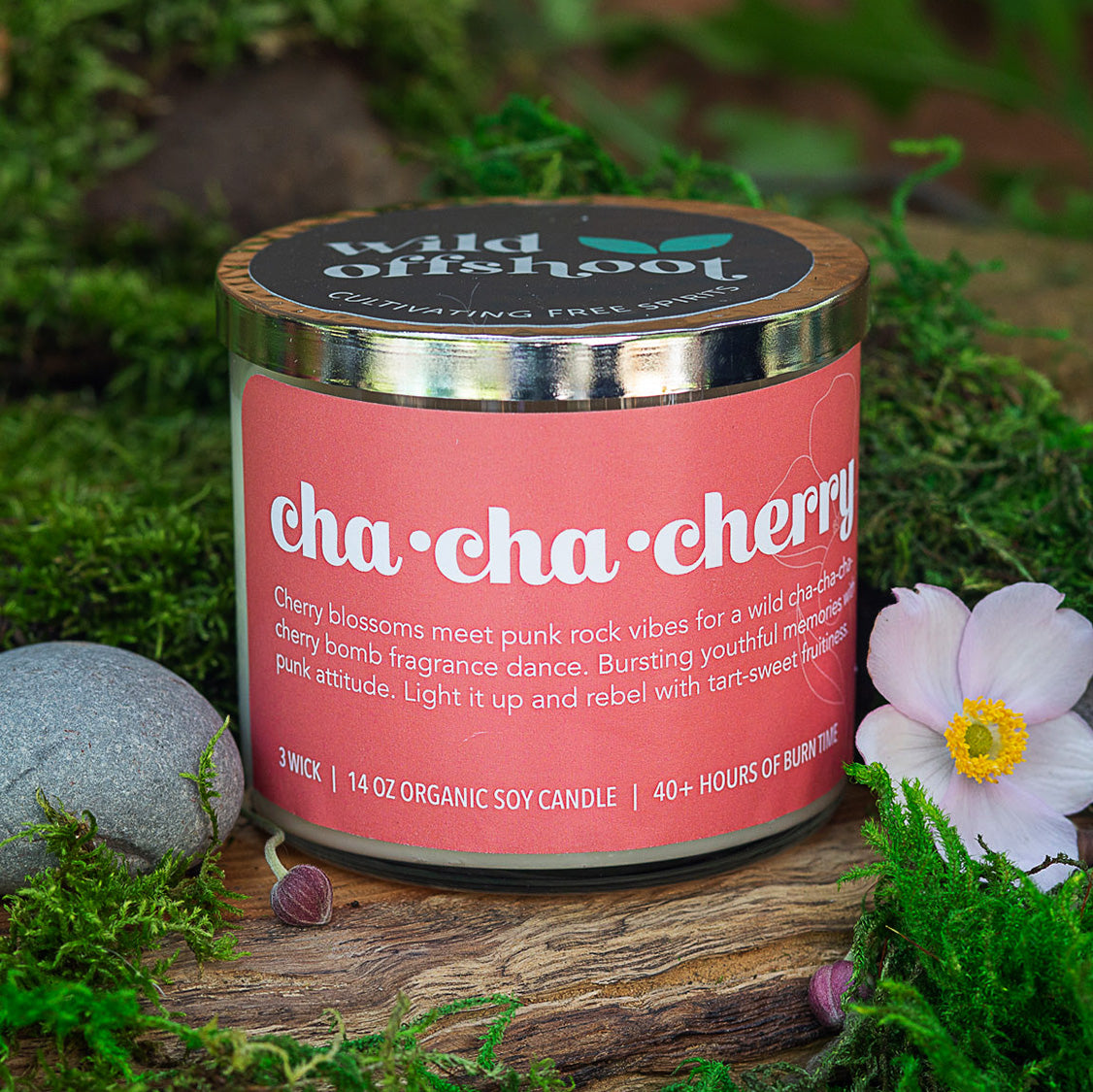 A pink candle jar soy candle with a silver metal lid, labeled 'Cha Cha Cherry' with a silver metal lid and 40 hours of burn time.