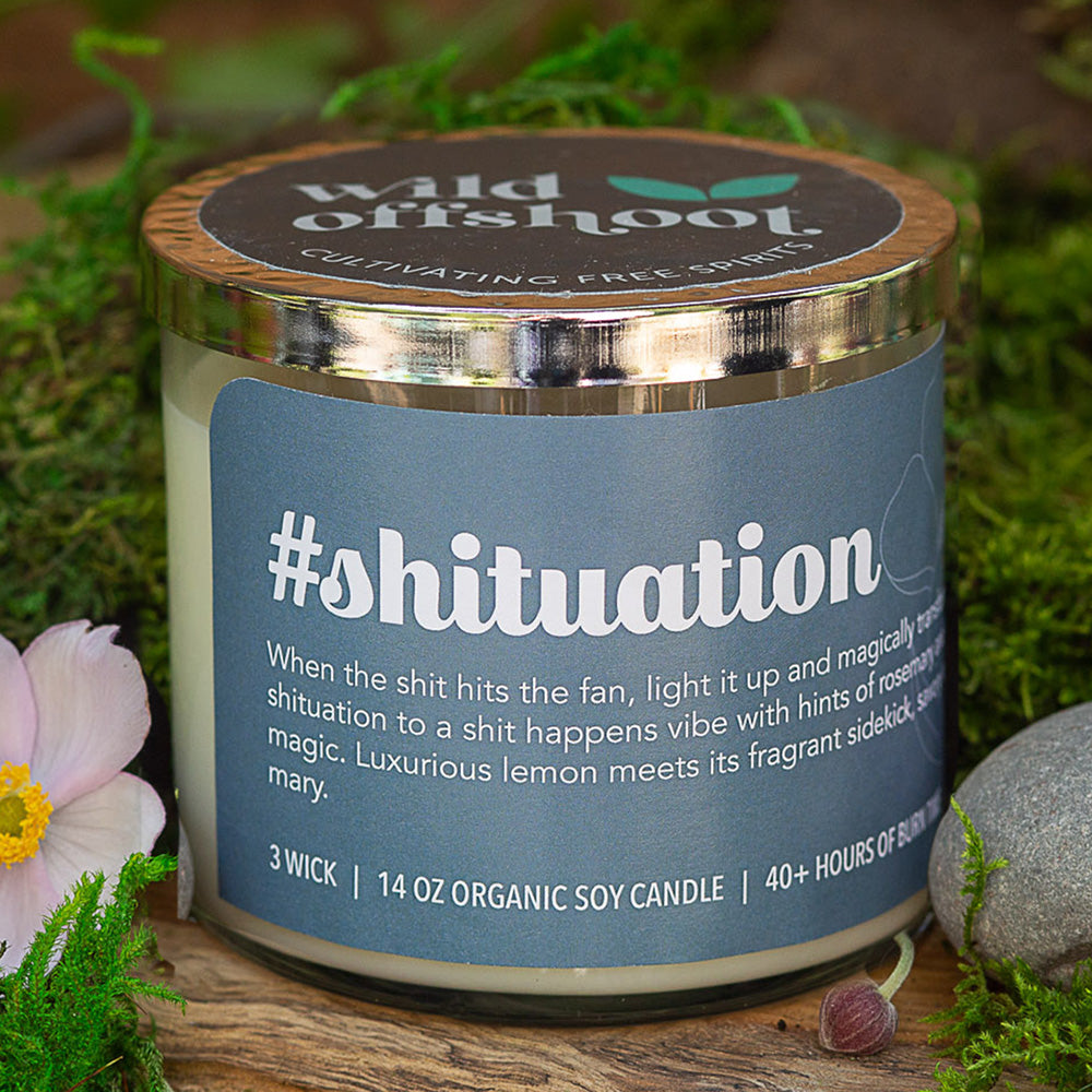 A white soy candle with a silver metal lid, labeled '#shituation' with text indicating a rosemary and lemon scent, and 40 hours of burn time.
