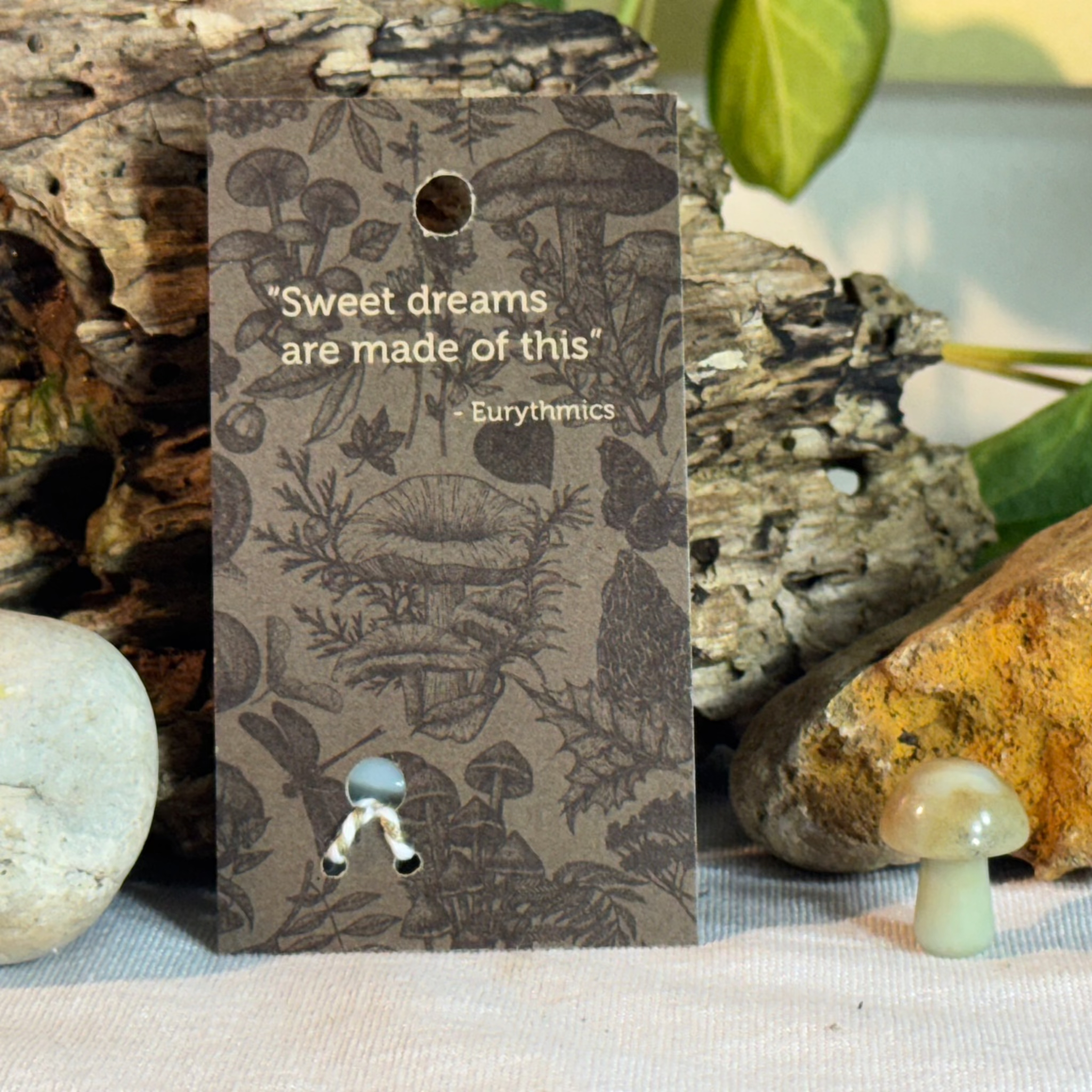 Card with mushroom design and  Eurythmics quote on a natural background