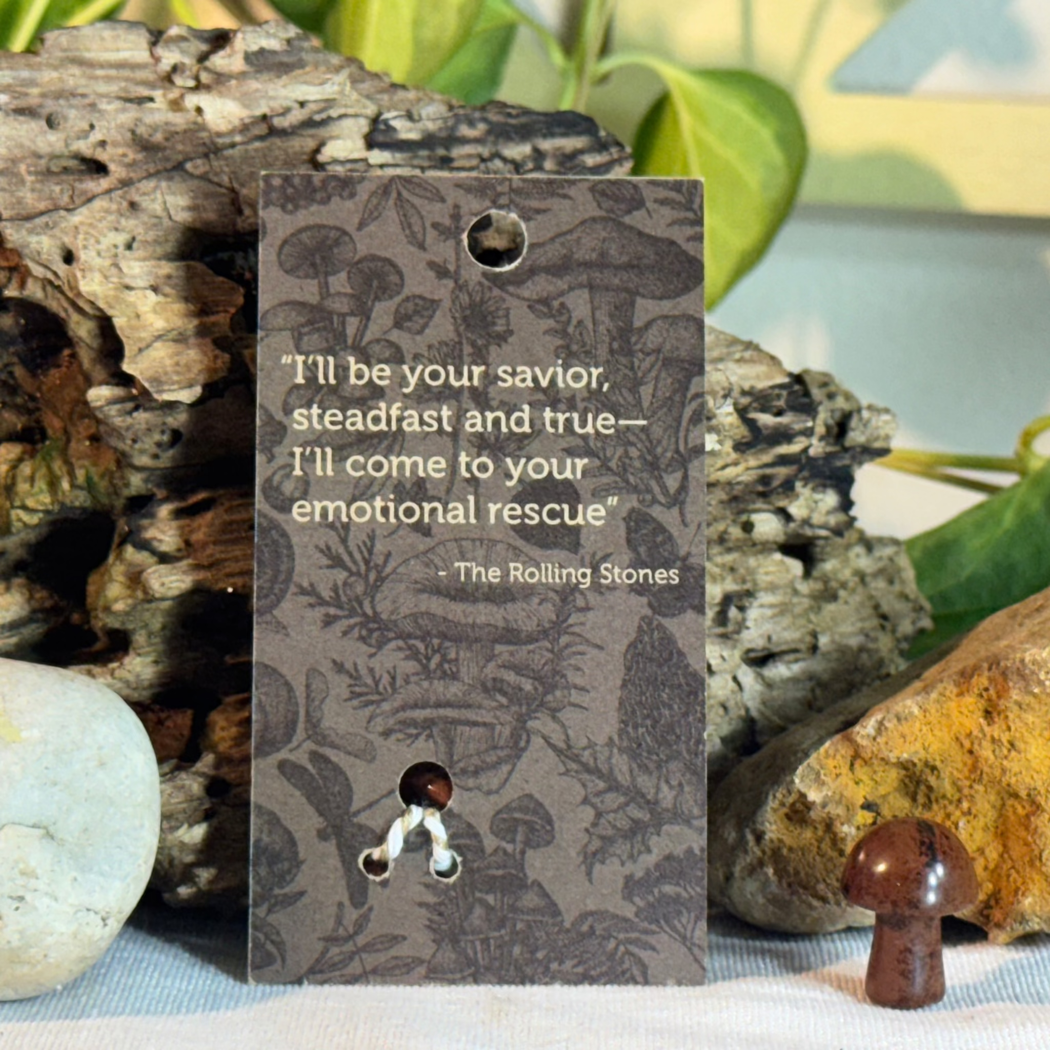 Card with mushroom design and Rolling Stones quote on a natural background