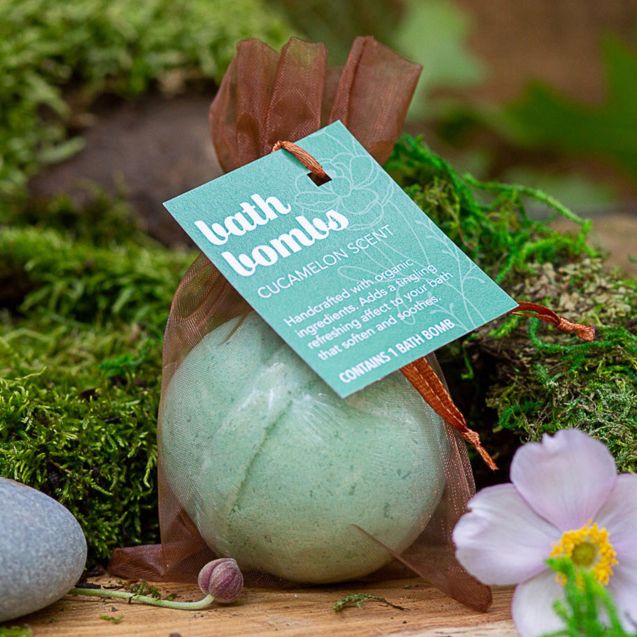 Wild Offshoot Cucamelon scent bath bomb - packaged in a rust sheer bag with a label.