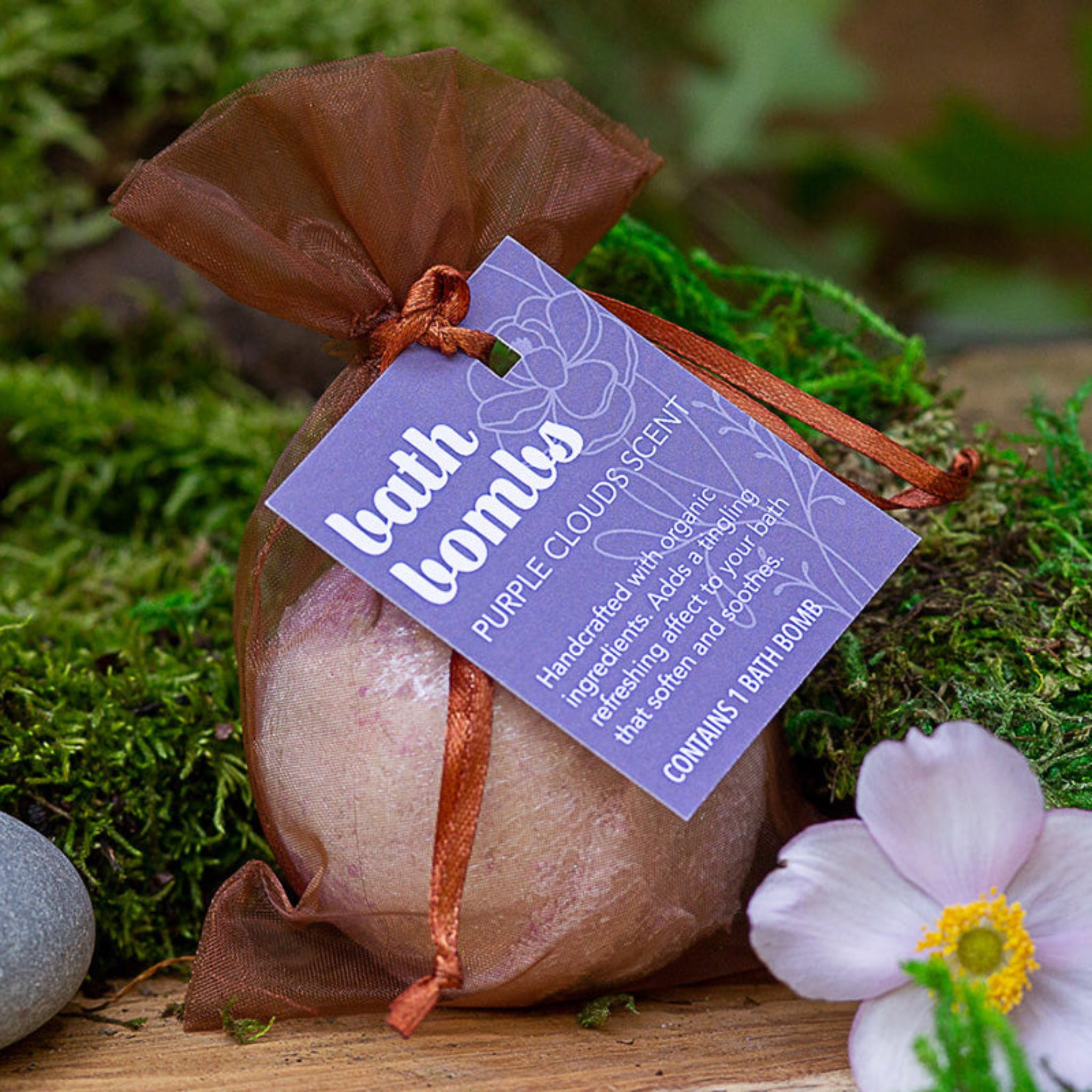Bath Bomb labeled "Purple Clouds" with scents of lavender in a rust silk bag