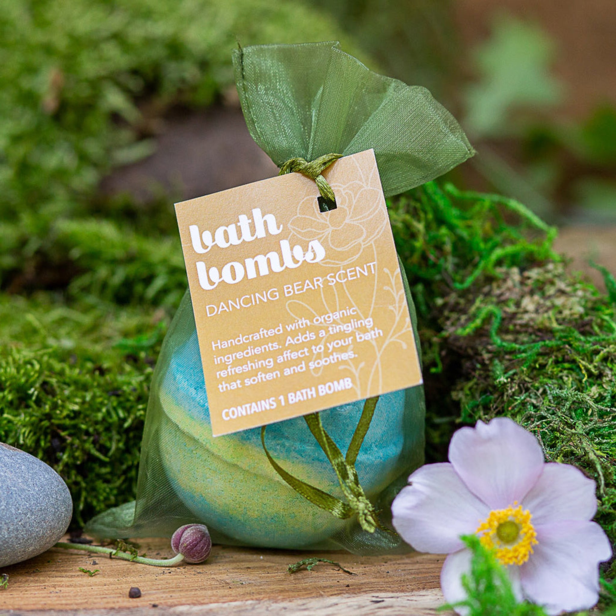 Bath Bomb in a green silk bag with a label that reads "Bath Bombs Dancing Bear Scent".